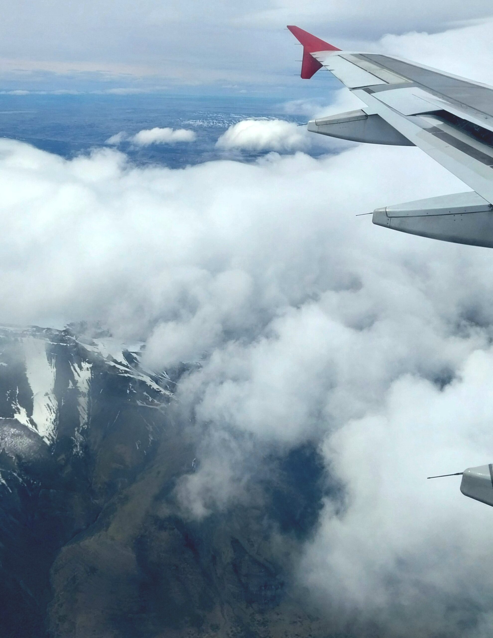 A plane flies over the Andes mountains in Chile.