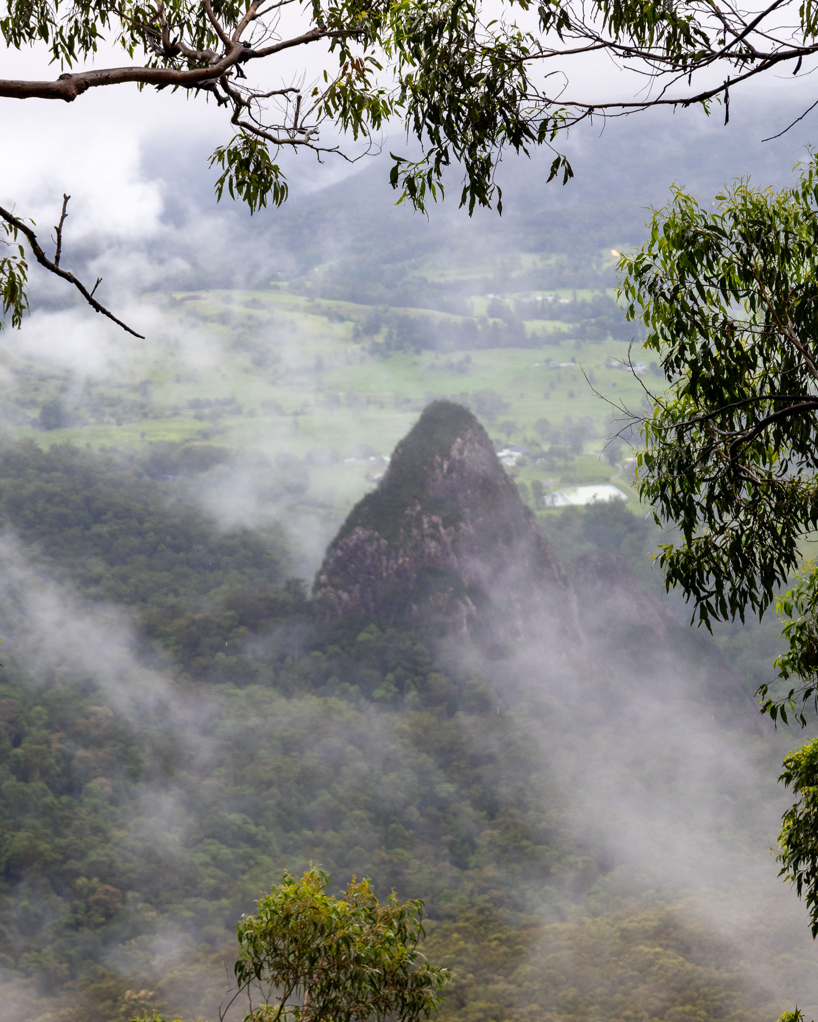 The unusual geological feature known as Egg Rock peeks through the mist.