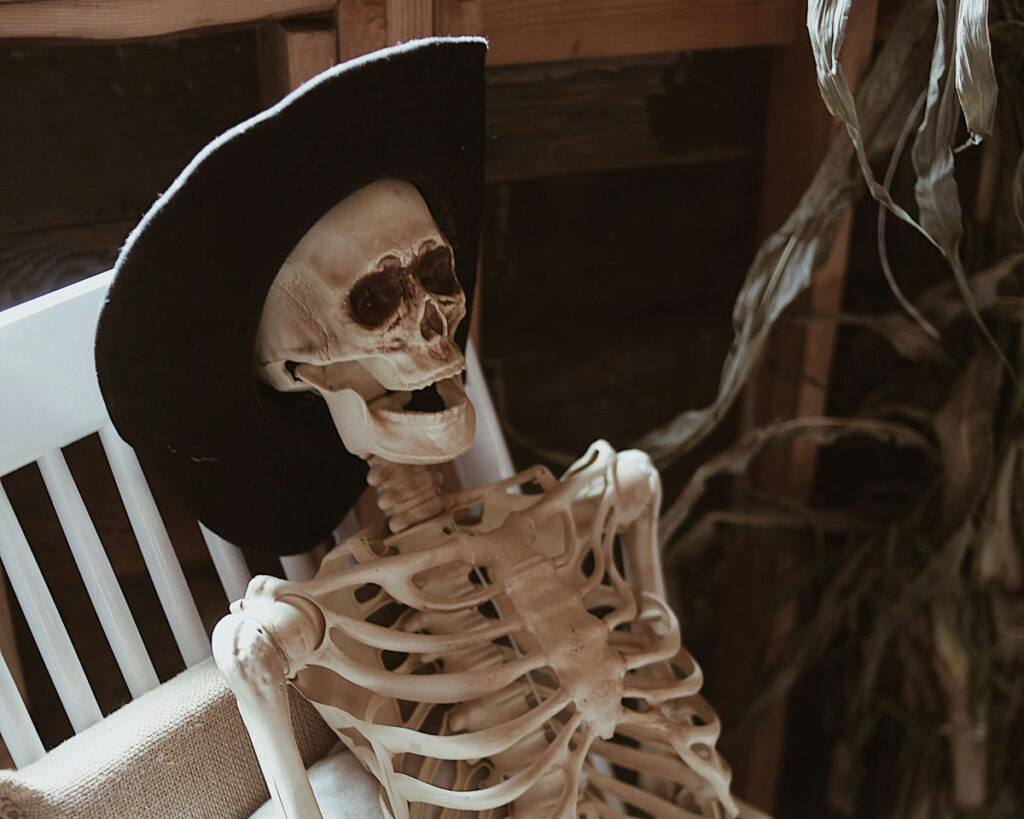 A skeleton sits in a chair. From the delays freelance writers sometimnes experience with payment, you'd expect that everyone in the accounting team has died.